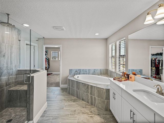 12808 Boggy Creek Dr, Riverview, FL 33579 - full bath featuring a stall shower, vanity, a garden tub, a spacious closet, and a textured ceiling