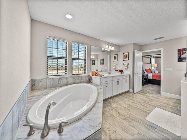 12808 Boggy Creek Dr, Riverview, FL 33579 - full bath with vanity, an inviting chandelier, connected bathroom, visible vents, and a bath