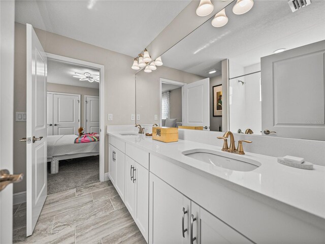 12808 Boggy Creek Dr, Riverview, FL 33579 - bathroom featuring double vanity, visible vents, a shower, and a sink