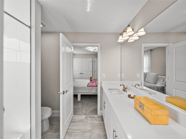 12808 Boggy Creek Dr, Riverview, FL 33579 - bathroom with baseboards, connected bathroom, toilet, and vanity
