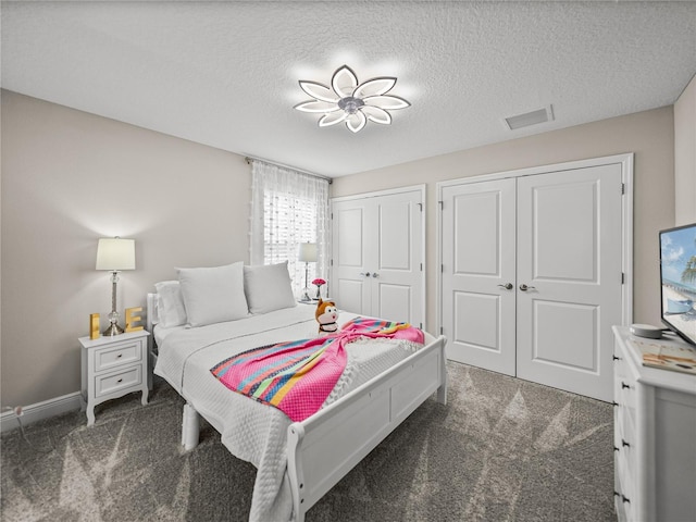12808 Boggy Creek Dr, Riverview, FL 33579 - carpeted bedroom with baseboards, visible vents, two closets, and a textured ceiling