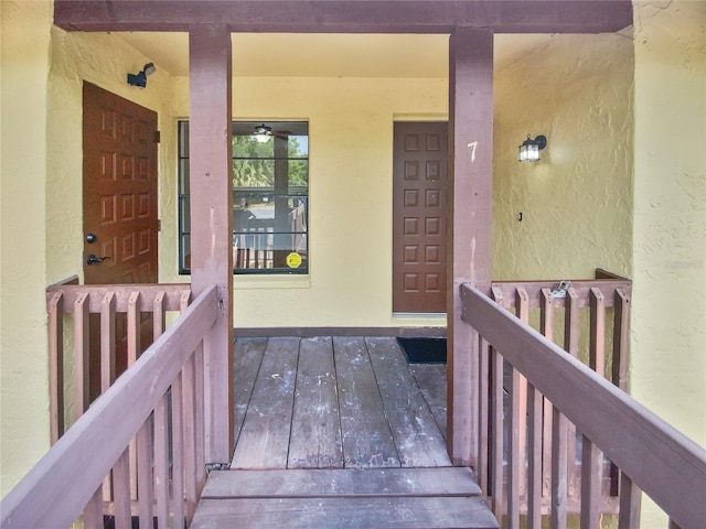 entrance to property featuring stucco siding