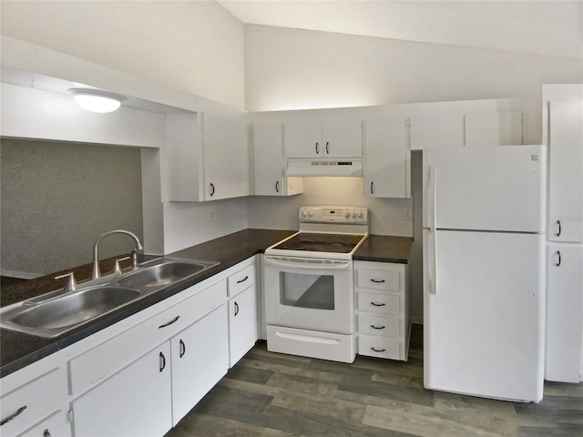 kitchen with under cabinet range hood, a sink, dark countertops, white appliances, and dark wood-style flooring