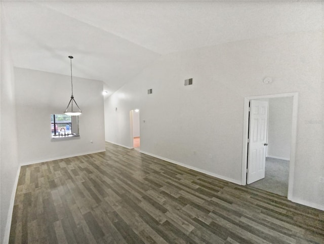 unfurnished living room with visible vents, baseboards, dark wood-type flooring, and high vaulted ceiling