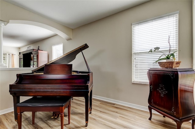 4250 Warwick Hills Dr, Wesley Chapel, FL 33543 - sitting room featuring wood finished floors, baseboards, decorative columns, and arched walkways