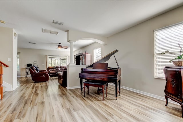 4250 Warwick Hills Dr, Wesley Chapel, FL 33543 - sitting room with ornate columns, light wood finished floors, arched walkways, and ceiling fan