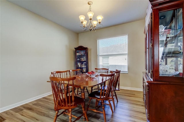 4250 Warwick Hills Dr, Wesley Chapel, FL 33543 - dining area featuring a chandelier, baseboards, and light wood-style flooring