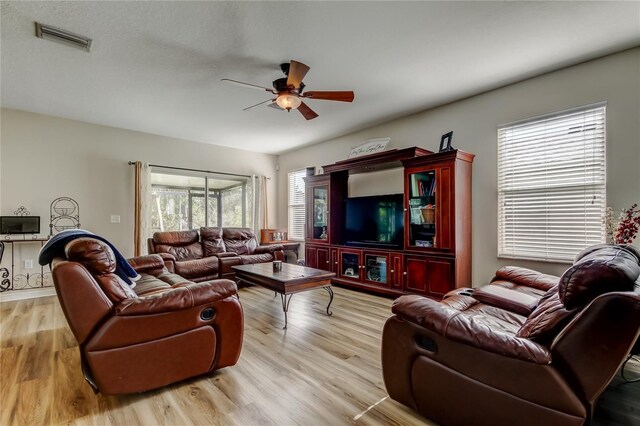 4250 Warwick Hills Dr, Wesley Chapel, FL 33543 - living area with a ceiling fan and light wood-style floors