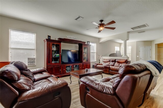 4250 Warwick Hills Dr, Wesley Chapel, FL 33543 - living area with ornate columns, light wood-style floors, and a ceiling fan