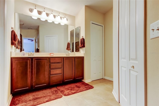 4250 Warwick Hills Dr, Wesley Chapel, FL 33543 - bathroom featuring tile patterned flooring, double vanity, a closet, and baseboards