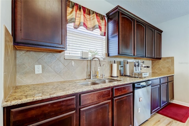 4250 Warwick Hills Dr, Wesley Chapel, FL 33543 - kitchen featuring dishwasher, a sink, light stone counters, decorative backsplash, and light wood-style flooring