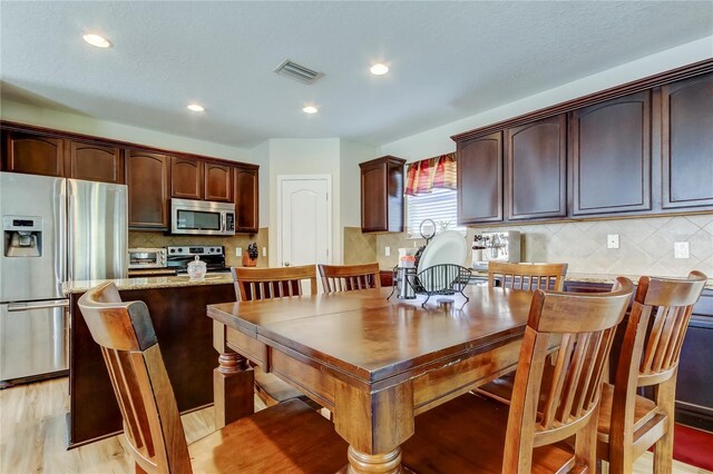 4250 Warwick Hills Dr, Wesley Chapel, FL 33543 - dining room with recessed lighting and light wood finished floors