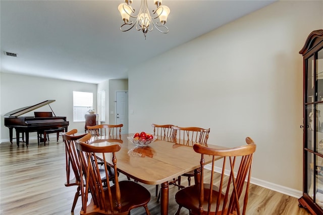 4250 Warwick Hills Dr, Wesley Chapel, FL 33543 - dining room featuring light wood-type flooring, a chandelier, and baseboards