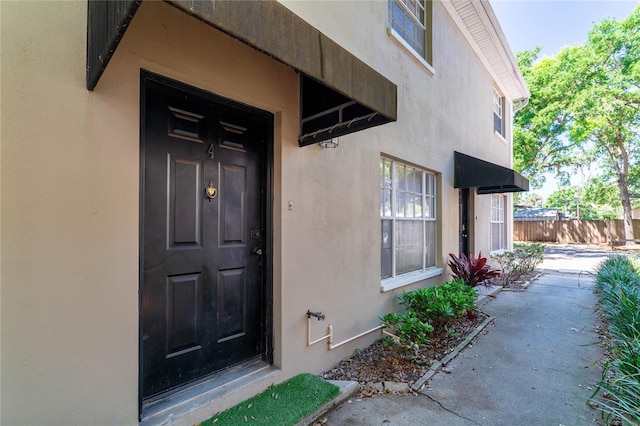 408 S Arrawana Ave Unit B4, Tampa, FL 33609 - view of exterior entry featuring stucco siding and fence