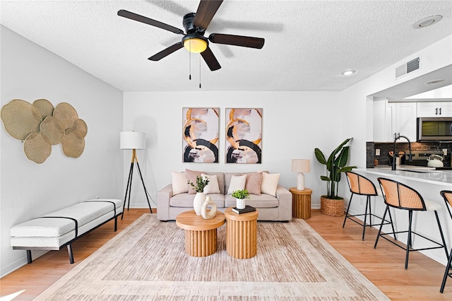 408 S Arrawana Ave Unit B4, Tampa, FL 33609 - living area with light wood-style floors, visible vents, and a textured ceiling
