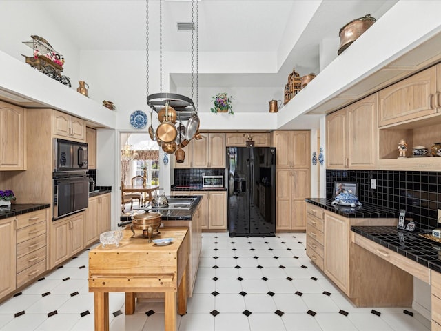 kitchen with black appliances, light floors, and light brown cabinetry