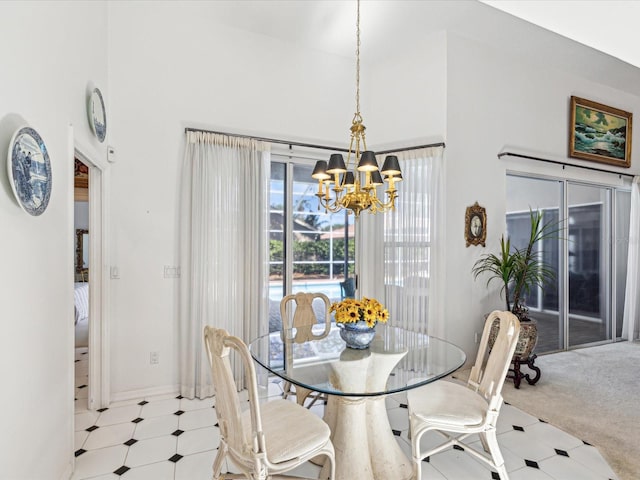 dining space featuring a chandelier, a towering ceiling, baseboards, and light floors