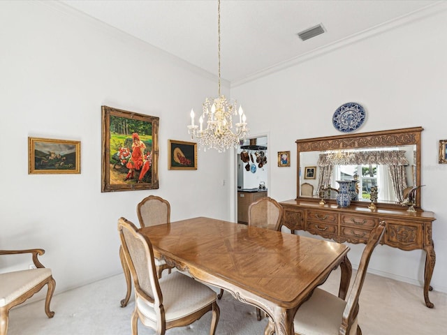 dining room featuring light carpet, a notable chandelier, ornamental molding, and visible vents