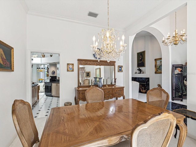 dining space with arched walkways, an inviting chandelier, ornamental molding, and visible vents