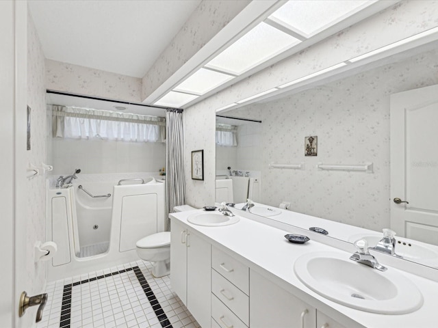 bathroom featuring wallpapered walls, a sink, and tile patterned flooring