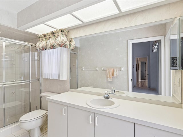 full bathroom with a shower stall, tile patterned floors, vanity, and toilet