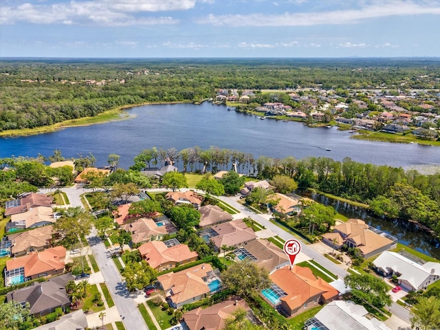 bird's eye view with a water view, a residential view, and a wooded view