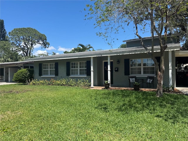 3316 S Shamrock Rd, Tampa, FL 33629 - ranch-style home featuring a front lawn, brick siding, and a carport