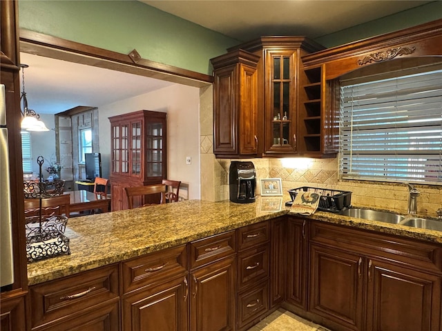 3316 S Shamrock Rd, Tampa, FL 33629 - kitchen with a sink, decorative backsplash, stone countertops, and glass insert cabinets