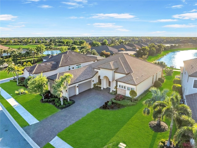drone / aerial view featuring a residential view and a water view
