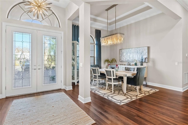 foyer entrance with visible vents, french doors, wood finished floors, and an inviting chandelier