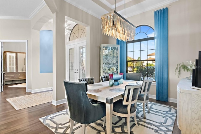 dining area featuring crown molding, french doors, wood finished floors, baseboards, and arched walkways