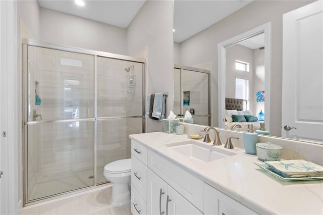 ensuite bathroom with a shower stall, toilet, vanity, ensuite bath, and tile patterned flooring