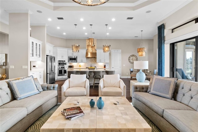 living area with dark wood-style floors, visible vents, a notable chandelier, and recessed lighting
