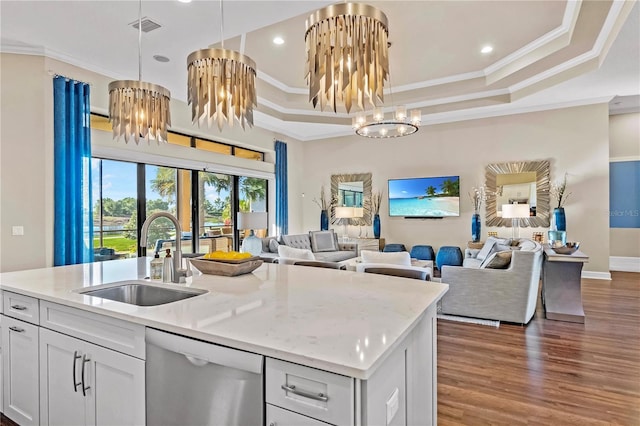 kitchen with stainless steel dishwasher, open floor plan, visible vents, and a sink