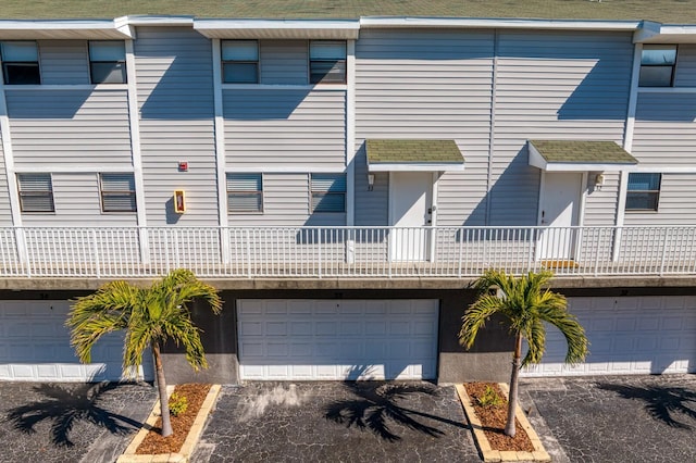 multi unit property with driveway and a garage