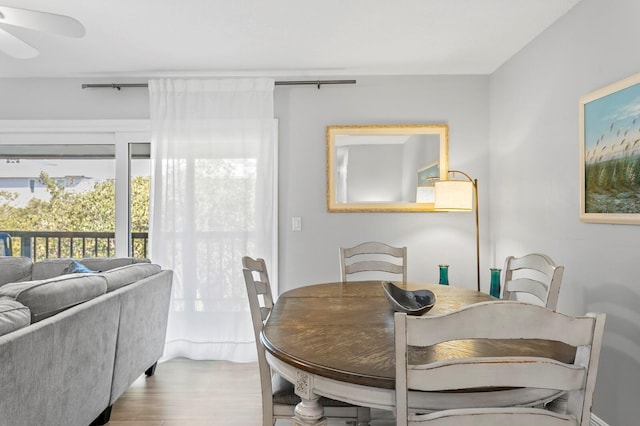 dining space featuring wood finished floors and ceiling fan