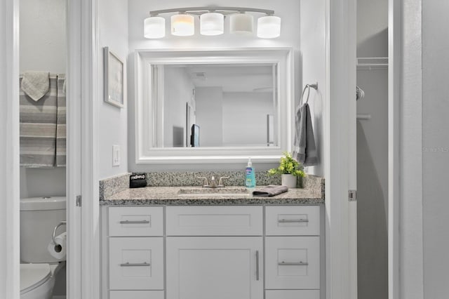 bathroom featuring toilet and vanity