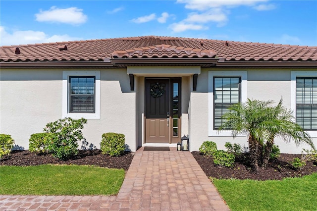 15635 Sacile Ln, Bradenton, FL 34211 - view of exterior entry featuring stucco siding and a tiled roof