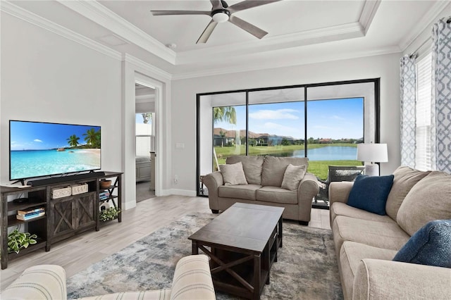 15635 Sacile Ln, Bradenton, FL 34211 - living room featuring a ceiling fan, a raised ceiling, and plenty of natural light