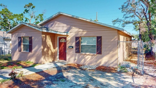 bungalow-style house with fence