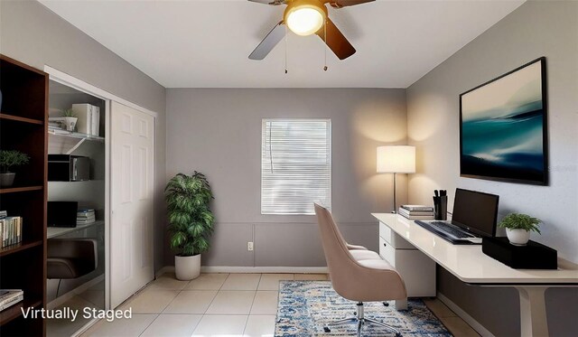 office with light tile patterned floors, baseboards, and ceiling fan