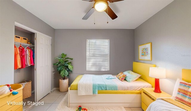 bedroom with tile patterned floors, a closet, and ceiling fan