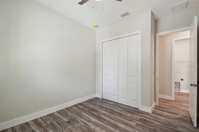 4559 Mitcher Rd, New Port Richey, FL 34652 - unfurnished bedroom with dark wood-style flooring, a closet, and ceiling fan