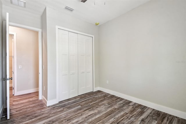 4559 Mitcher Rd, New Port Richey, FL 34652 - unfurnished bedroom with dark wood-style floors and a closet