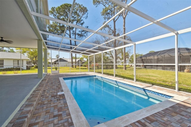 4559 Mitcher Rd, New Port Richey, FL 34652 - outdoor pool featuring a yard, glass enclosure, a patio area, and ceiling fan