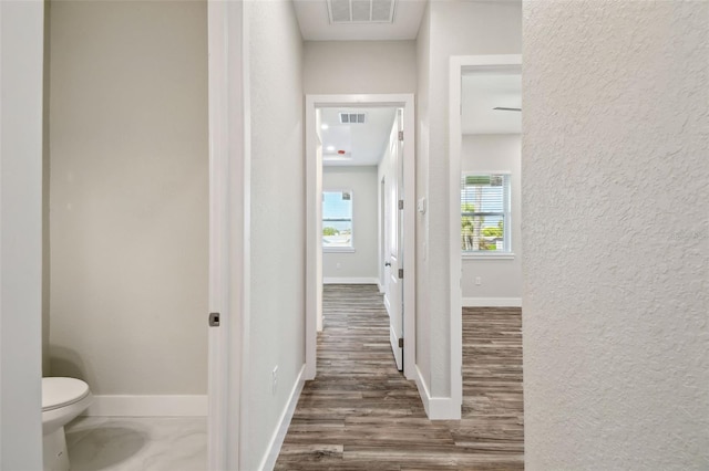 4559 Mitcher Rd, New Port Richey, FL 34652 - corridor with a textured wall and wood finished floors