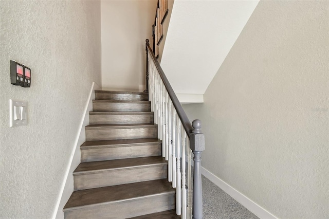 4559 Mitcher Rd, New Port Richey, FL 34652 - staircase with baseboards and a textured wall