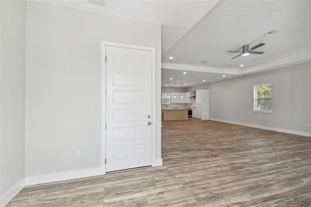 4559 Mitcher Rd, New Port Richey, FL 34652 - unfurnished living room with light wood-style flooring, a ceiling fan, and recessed lighting
