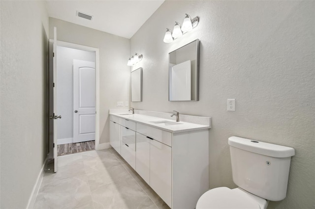 4559 Mitcher Rd, New Port Richey, FL 34652 - bathroom with double vanity and toilet