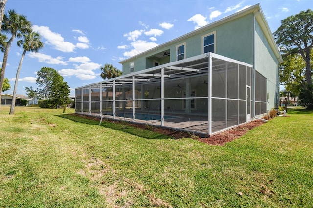 4559 Mitcher Rd, New Port Richey, FL 34652 - back of house featuring a ceiling fan, a lawn, stucco siding, and a patio area